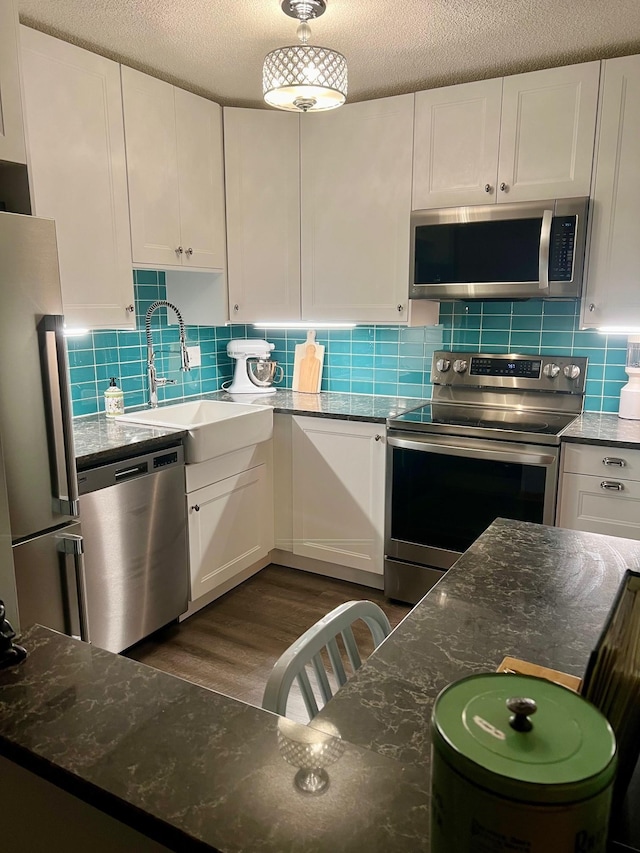 kitchen with white cabinets and appliances with stainless steel finishes