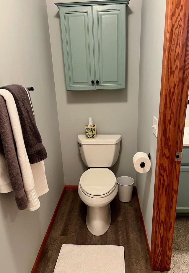 bathroom featuring toilet and wood-type flooring