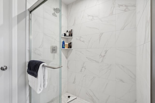 bathroom with a shower with shower door