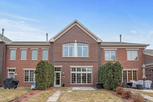 rear view of house featuring a yard and a patio area