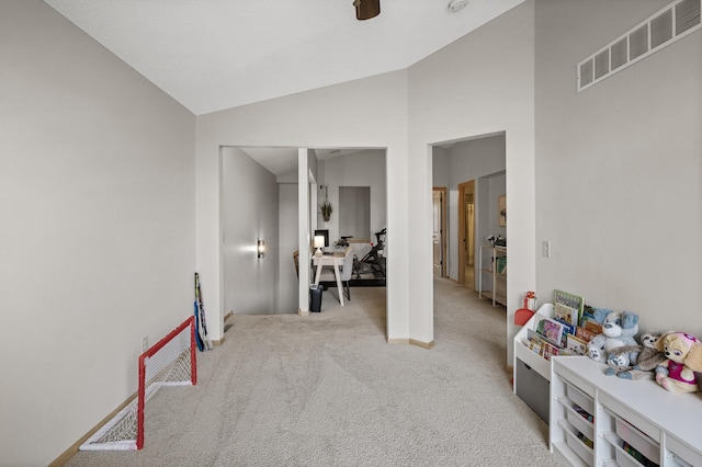 game room with lofted ceiling and light colored carpet