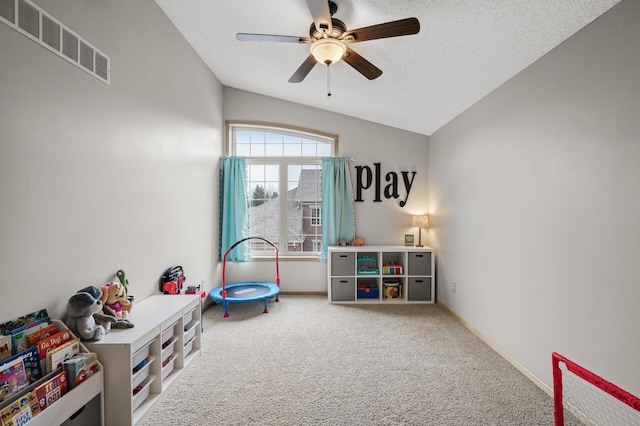 game room with ceiling fan, carpet floors, and a textured ceiling