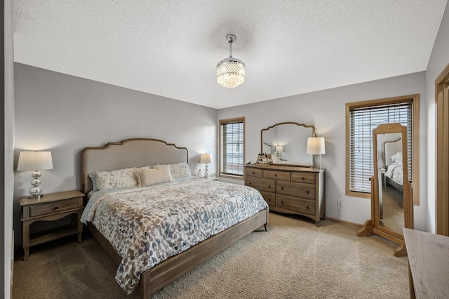 carpeted bedroom featuring a textured ceiling