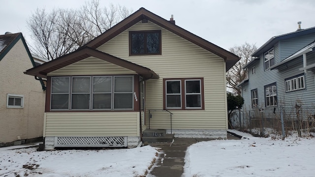 view of snow covered rear of property