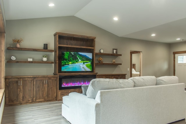 living room with lofted ceiling and light wood-type flooring