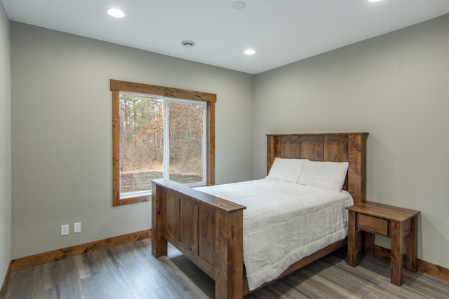 bedroom with hardwood / wood-style flooring