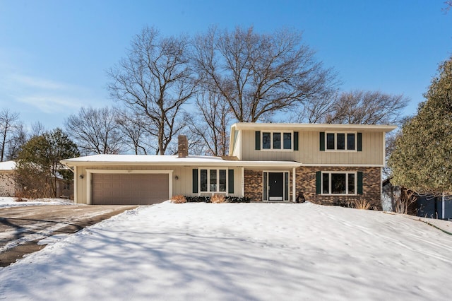 traditional-style house with brick siding, a chimney, and an attached garage