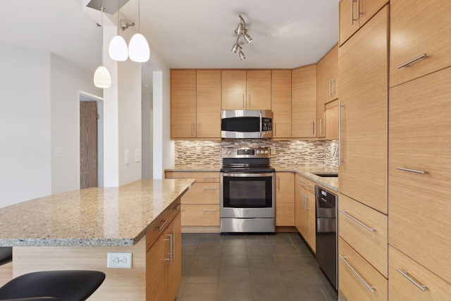 kitchen with dark tile patterned flooring, light brown cabinets, stainless steel appliances, tasteful backsplash, and hanging light fixtures