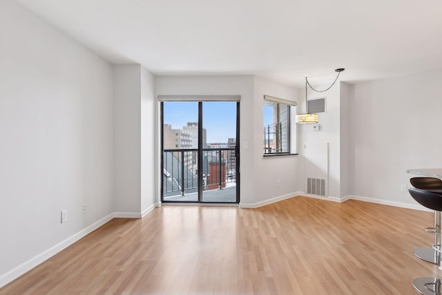 spare room featuring light wood-type flooring