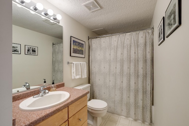 bathroom with toilet, a textured ceiling, and vanity