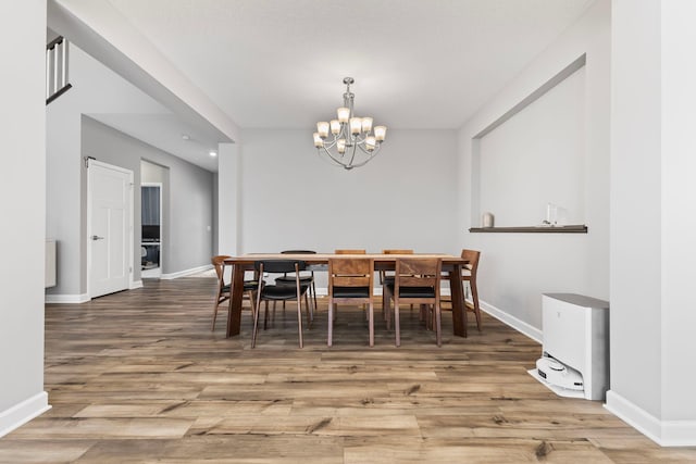 dining area featuring a notable chandelier and hardwood / wood-style floors