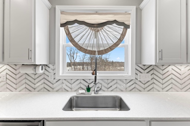 kitchen featuring sink, white cabinetry, and dishwasher