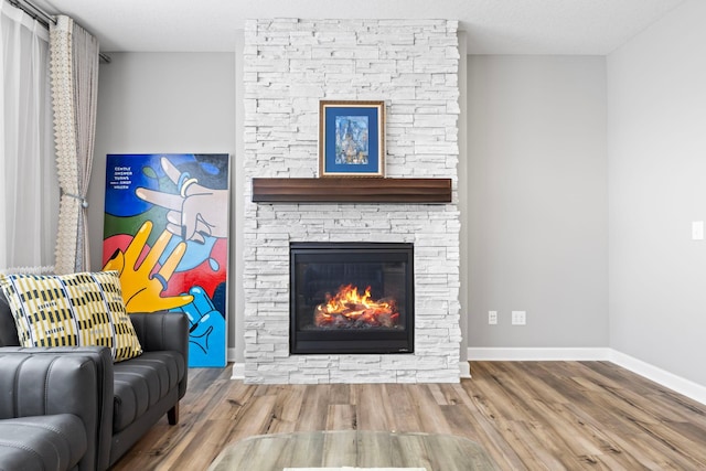 unfurnished living room with a fireplace, hardwood / wood-style floors, and a textured ceiling