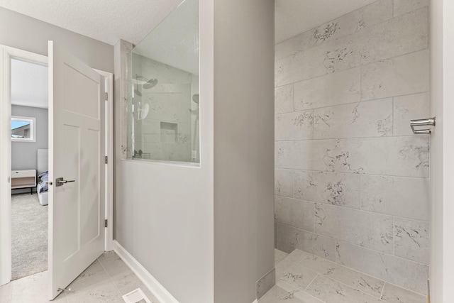 bathroom with tiled shower