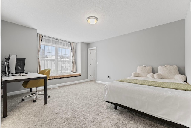 carpeted bedroom featuring a textured ceiling