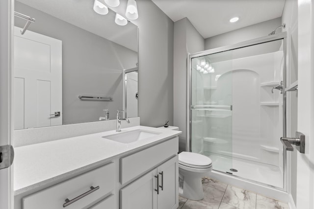 bathroom featuring toilet, an enclosed shower, and vanity