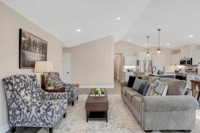 living room with light wood-type flooring and vaulted ceiling