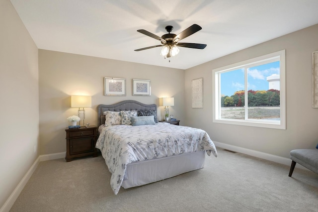 bedroom with light colored carpet and ceiling fan