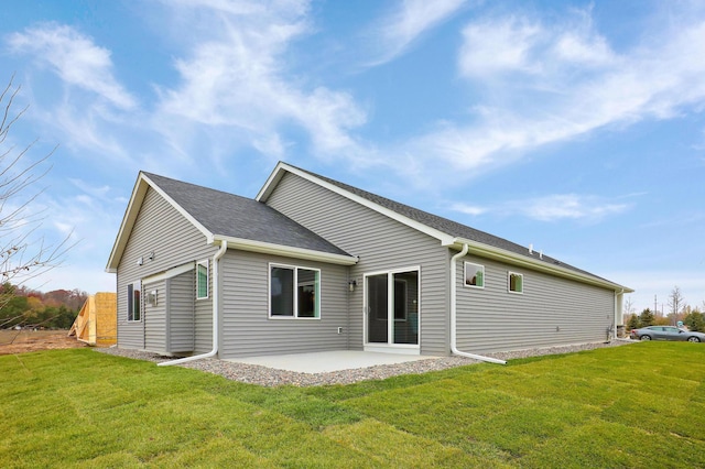 back of property featuring a patio and a yard