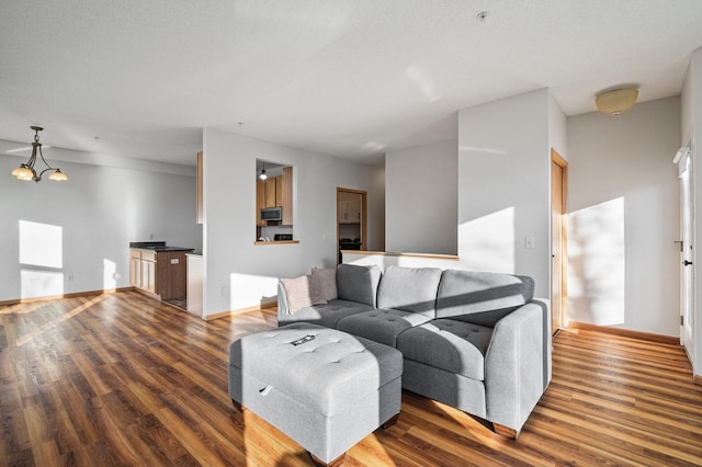 living room with an inviting chandelier and hardwood / wood-style floors