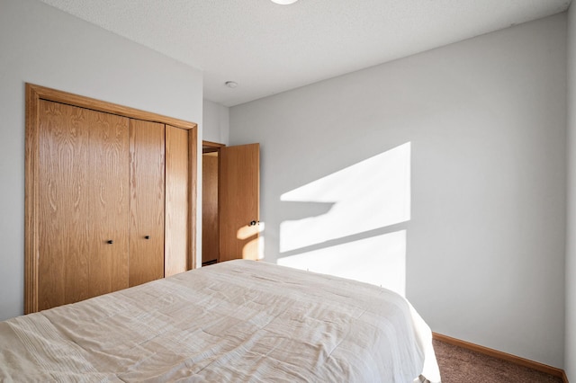 carpeted bedroom featuring a textured ceiling