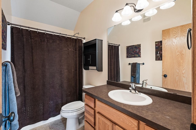 bathroom with lofted ceiling, vanity, toilet, and tile patterned flooring