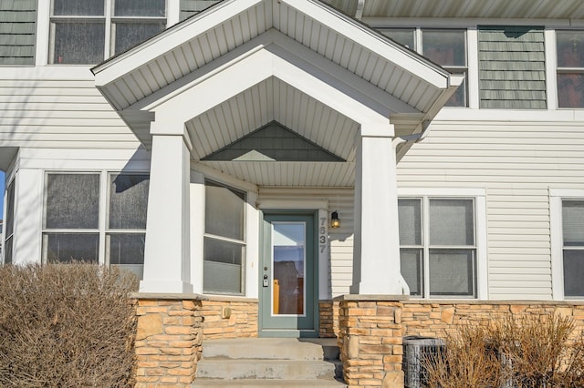 view of exterior entry featuring central AC unit