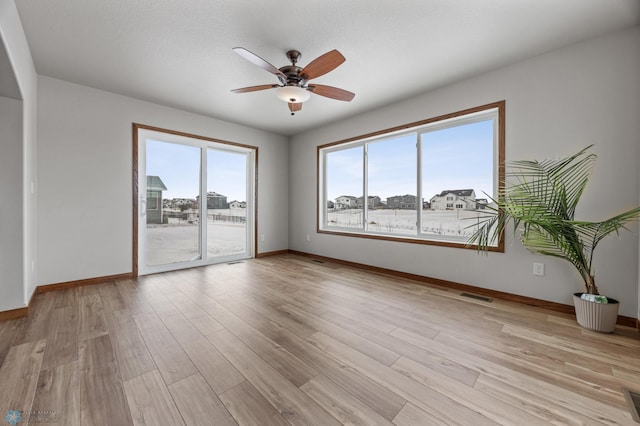 spare room featuring ceiling fan and light wood-type flooring