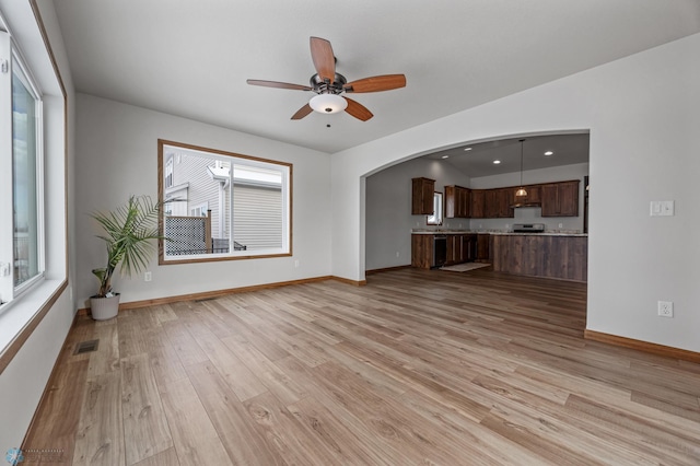 unfurnished living room featuring ceiling fan and light hardwood / wood-style floors