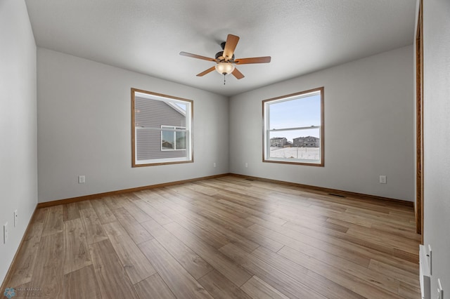 unfurnished room with ceiling fan and light wood-type flooring