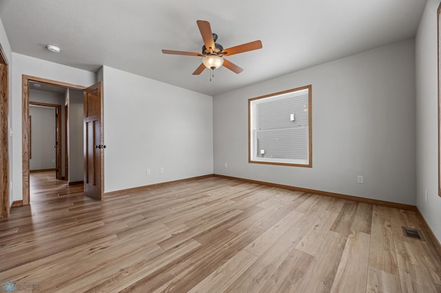 spare room with ceiling fan and light wood-type flooring