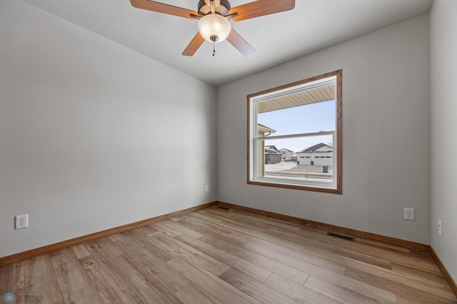 empty room featuring ceiling fan and light hardwood / wood-style flooring