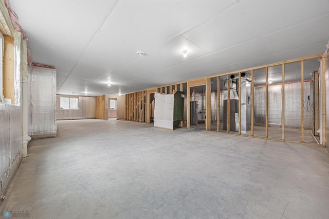 basement featuring water heater and heating unit