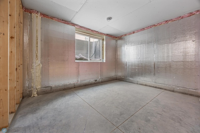 spare room featuring concrete flooring