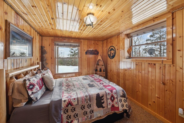 carpeted bedroom featuring wooden walls and wooden ceiling