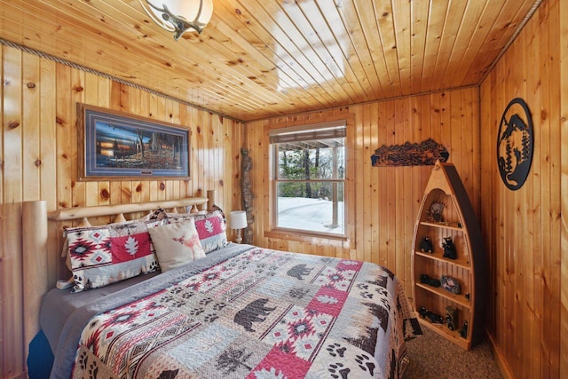 bedroom featuring wooden walls, wooden ceiling, and carpet