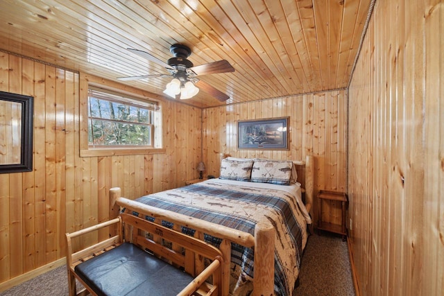 28255 Friendly Valley Rd, Washburn, WI 54891 - carpeted bedroom featuring wooden walls, wood ceiling, and a ceiling fan