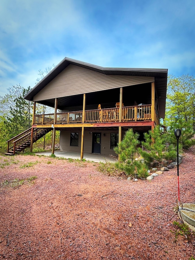 28255 Friendly Valley Rd, Washburn, WI 54891 - rear view of property with a wooden deck, stairway, and a patio