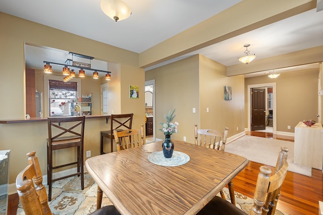 dining room featuring wood finished floors and baseboards