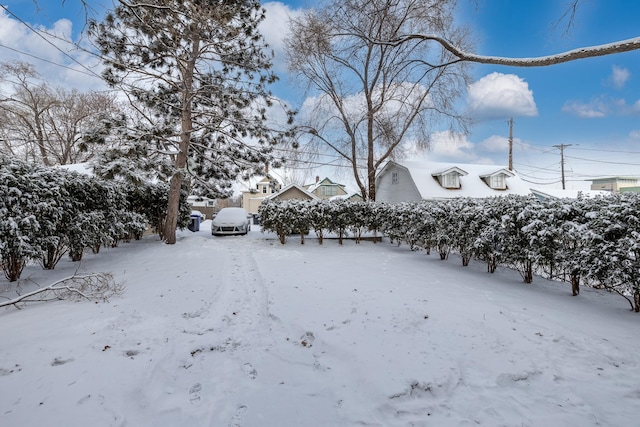 snowy yard with a garage