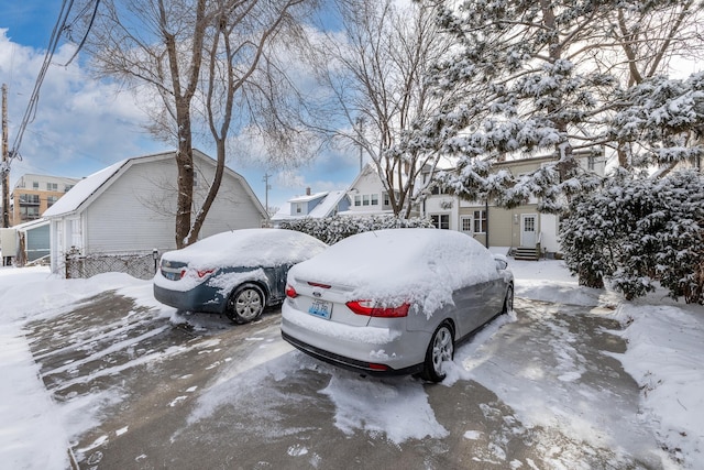 view of snow covered parking area