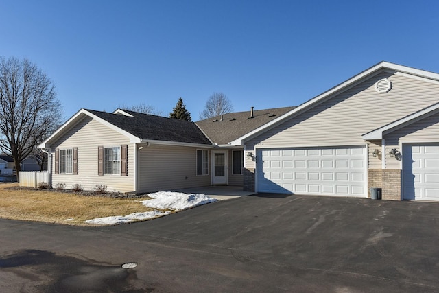 ranch-style home featuring a garage