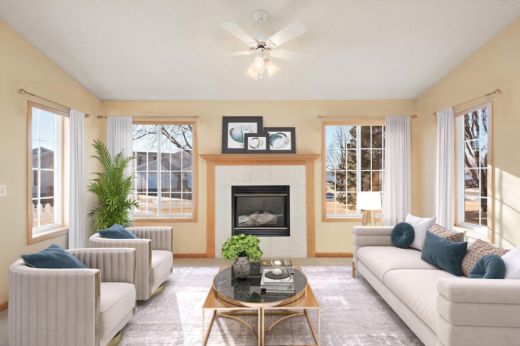 living area featuring carpet, a fireplace, vaulted ceiling, ceiling fan, and baseboards