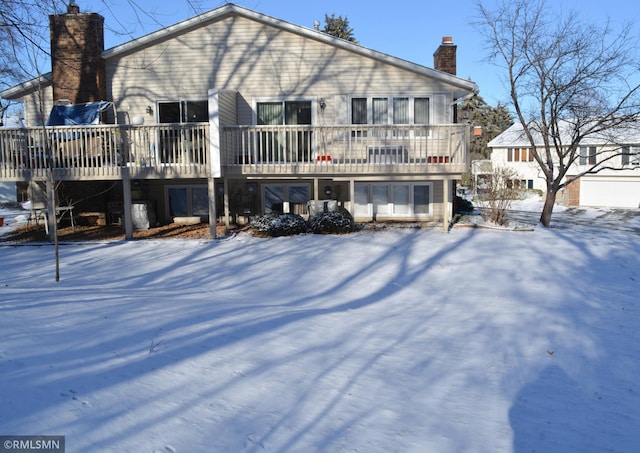 view of snow covered rear of property