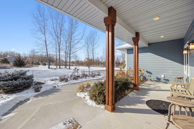 snow covered patio with covered porch