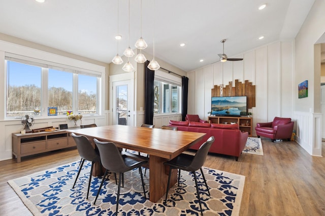 dining area with ceiling fan and light hardwood / wood-style floors