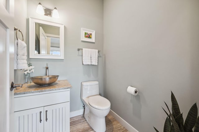 bathroom featuring hardwood / wood-style flooring, vanity, and toilet