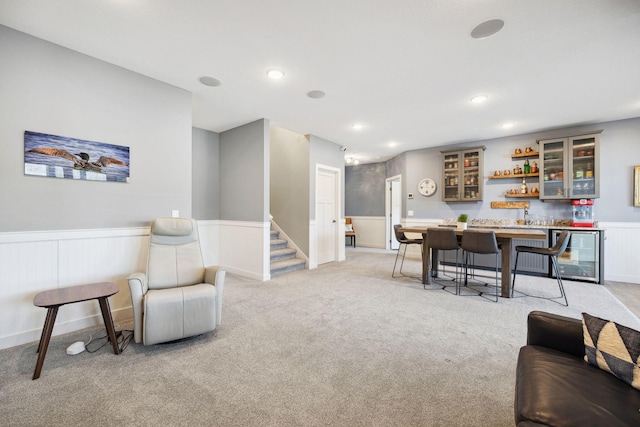 carpeted living room with wine cooler and indoor bar