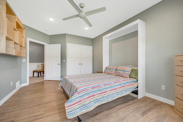 bedroom with light hardwood / wood-style flooring, a closet, and ceiling fan