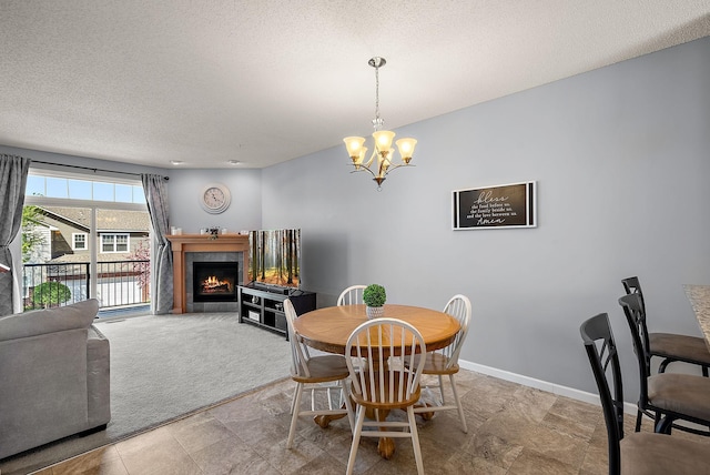 9668 Unity Ln N, Brooklyn Park, MN 55443 - dining room with a chandelier, a textured ceiling, a tiled fireplace, baseboards, and light colored carpet